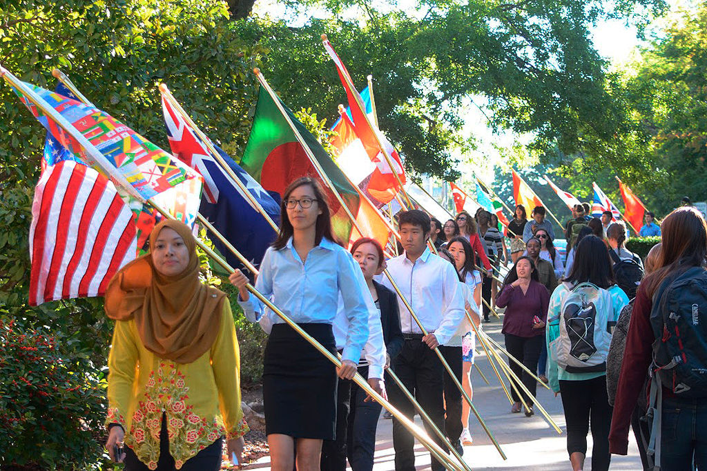 Nurfarahanani “Nani” Jude and Ashley Yong lead the International Day flag parade
